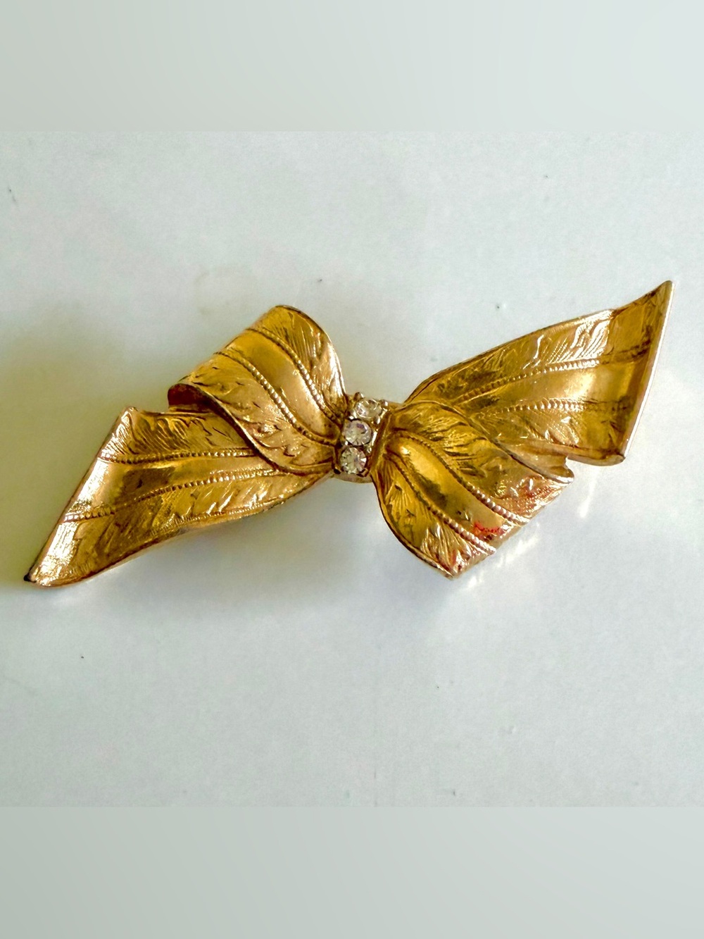 Gold Tone Bow Brooch with Rhinestone Accent
